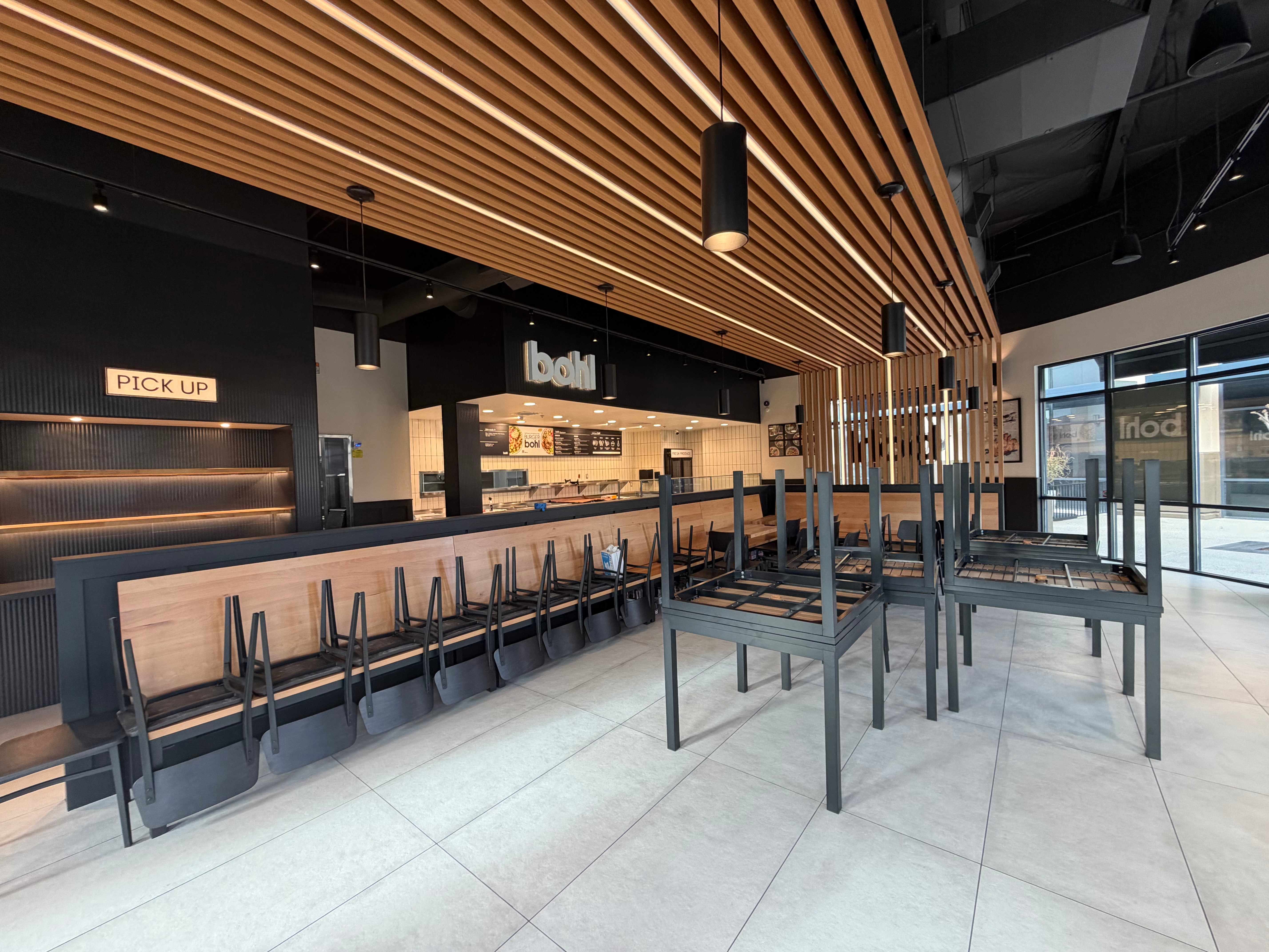 Bohl restaurant dining area with wood slat ceiling and modern lighting