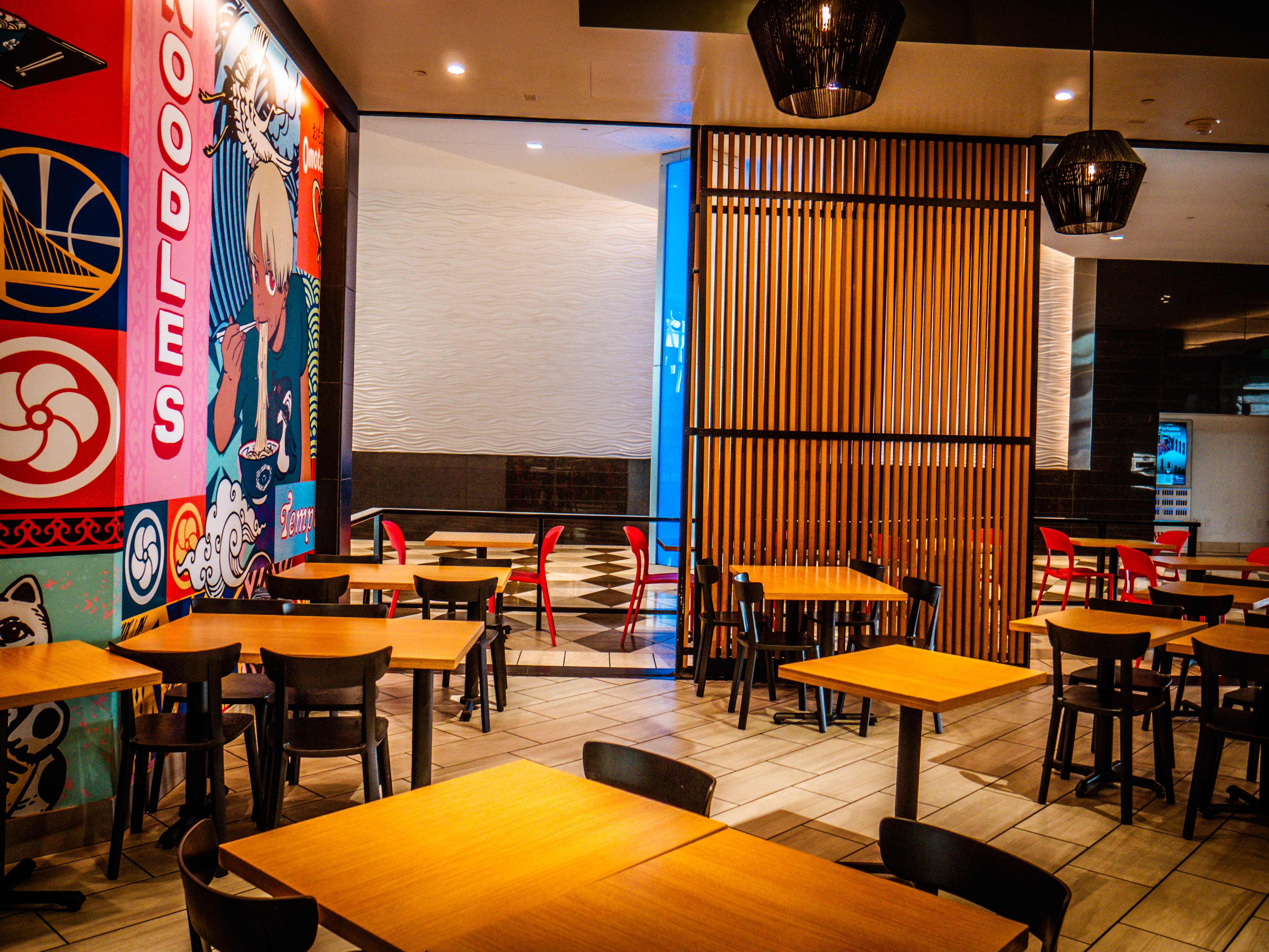 Complete interior dining space with anime murals, wooden tables, red chairs, and comprehensive restaurant layout ready for service