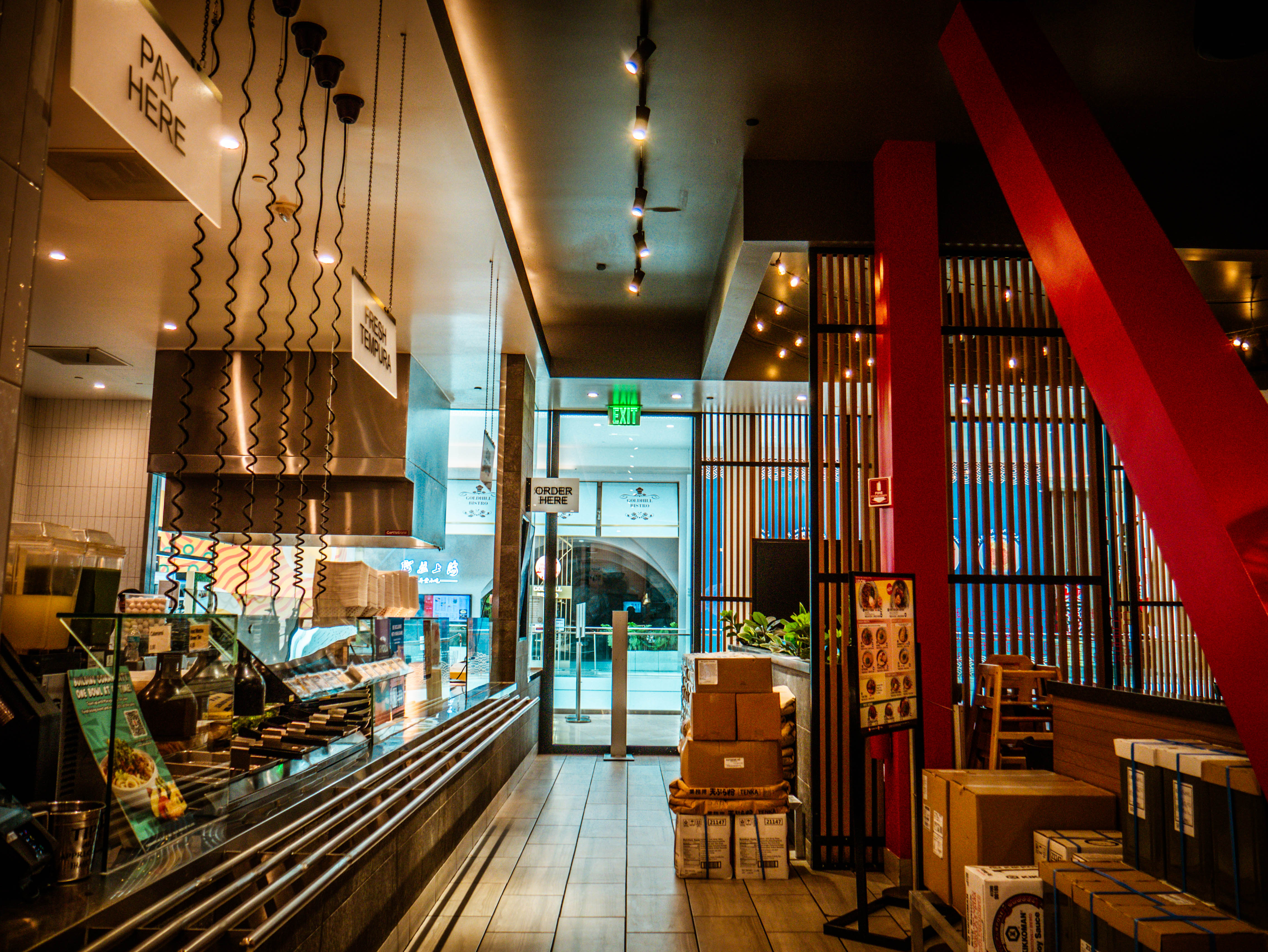 Service workflow area with 'PAY HERE' signage, ingredient storage, and efficient kitchen-to-customer flow design