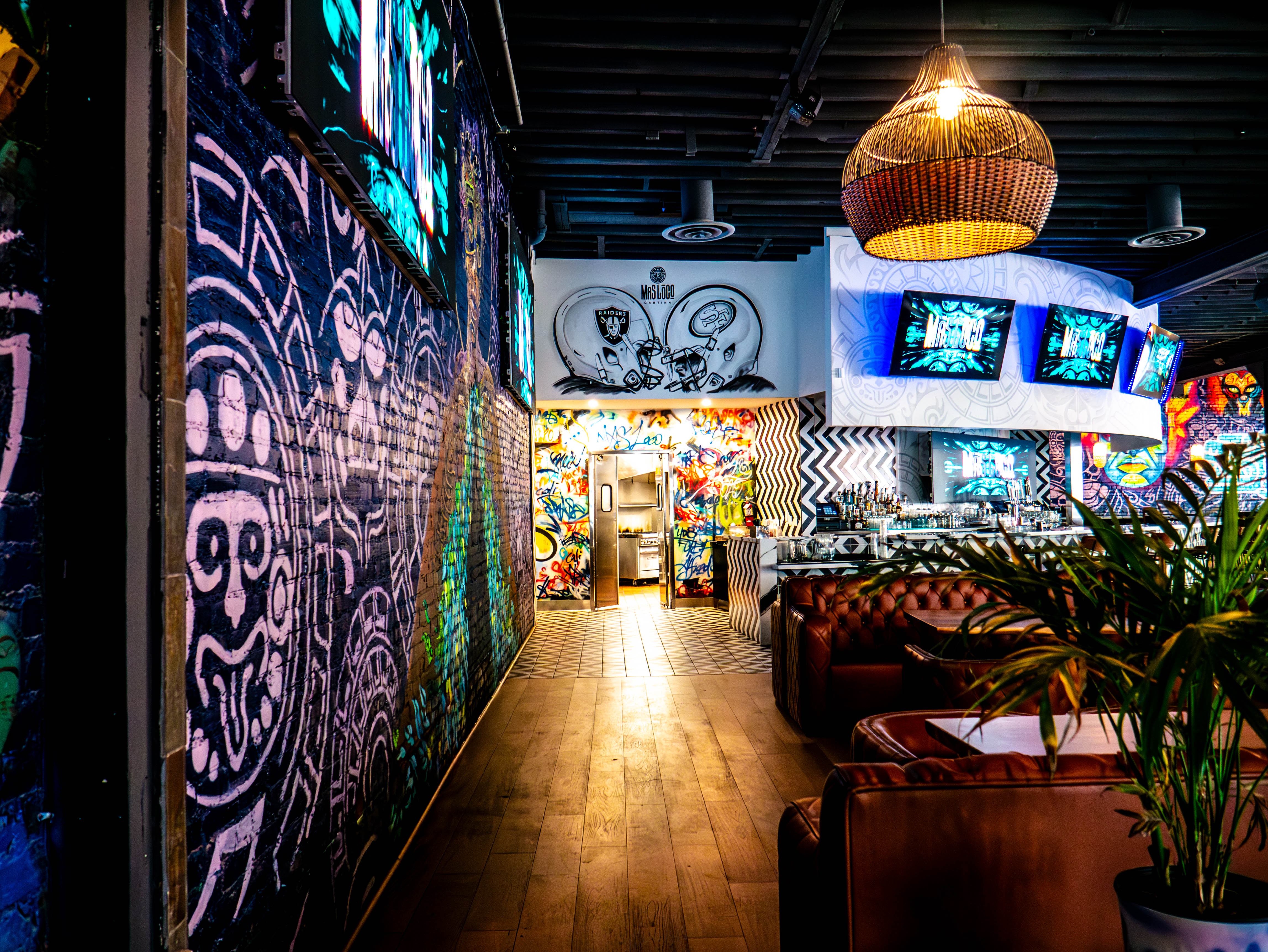 Corridor showcasing extensive murals and custom lighting