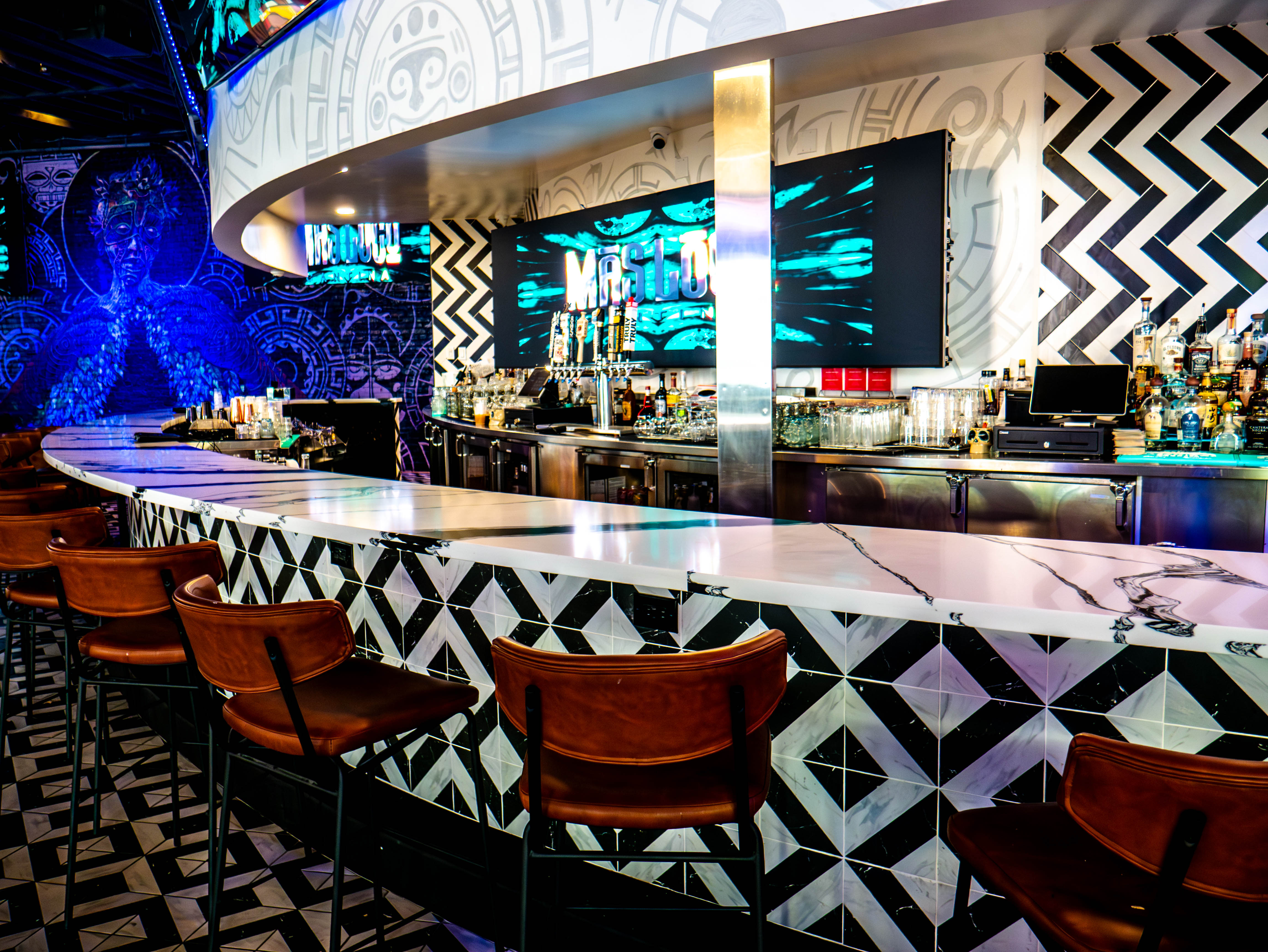 Full view of main bar with geometric patterns and multiple screens