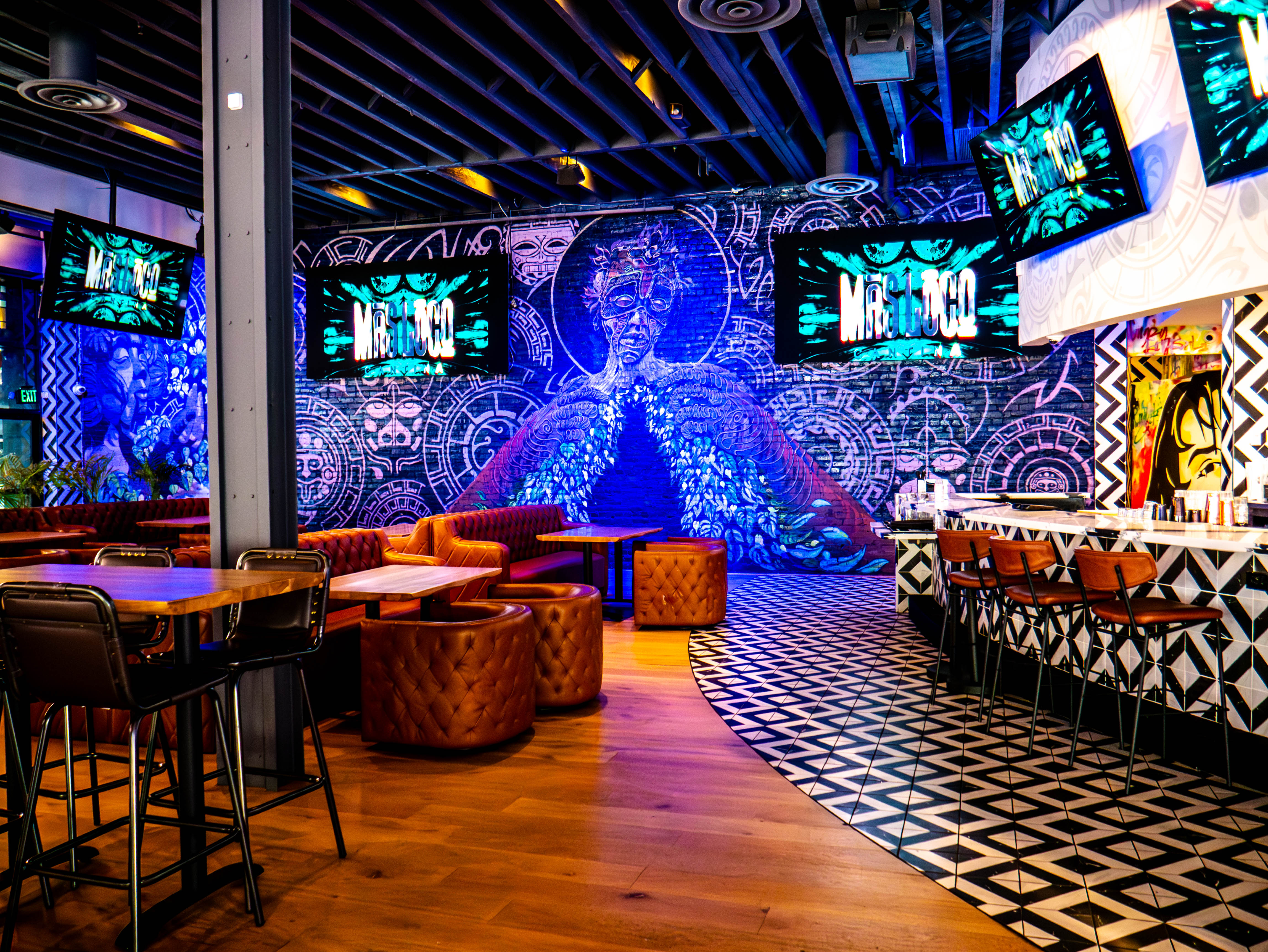 Dining space with dramatic blue Aztec warrior murals