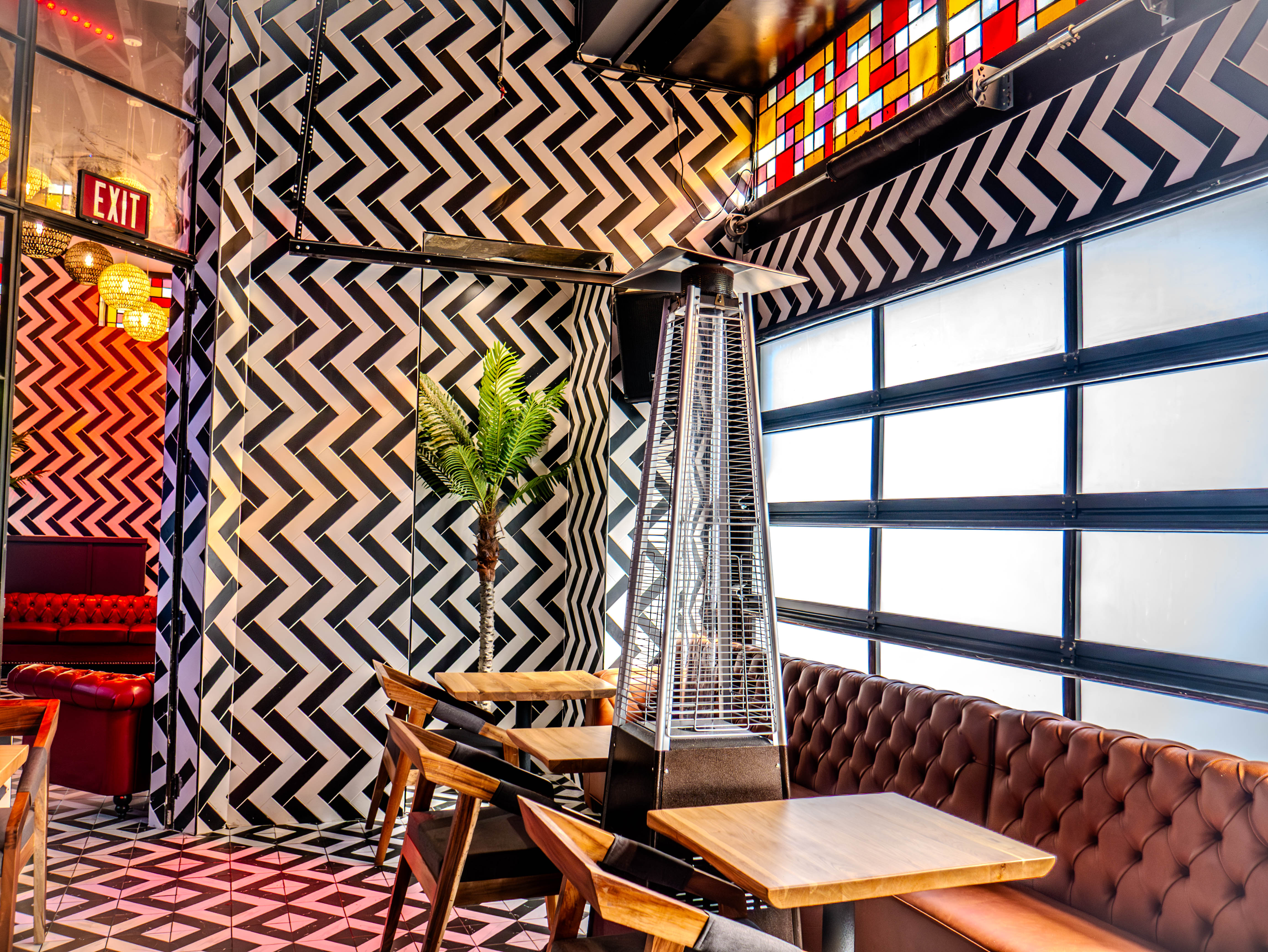 Patio seating area with geometric patterns and heat lamps