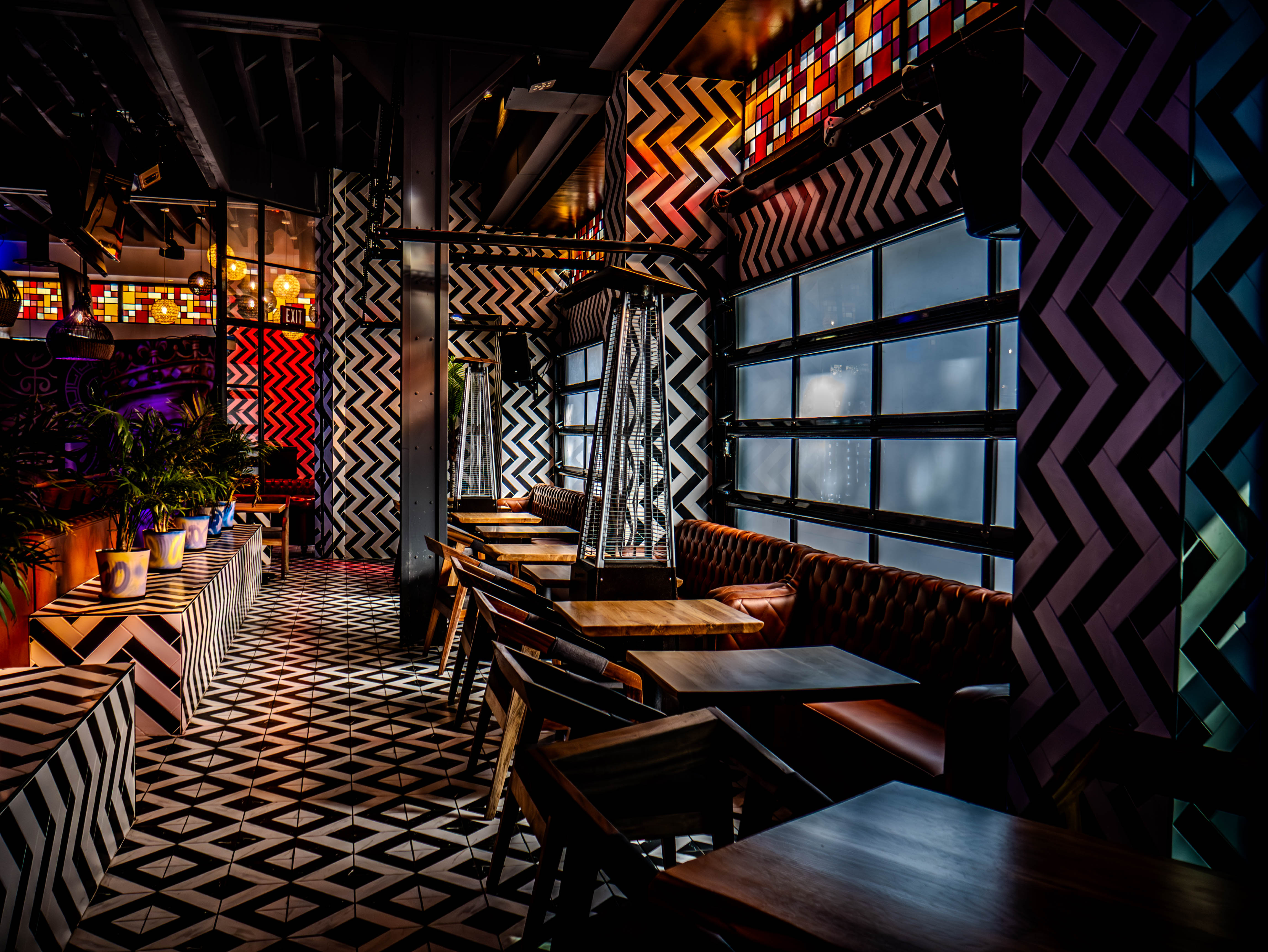 Upper level dining area with geometric patterns and industrial ceiling
