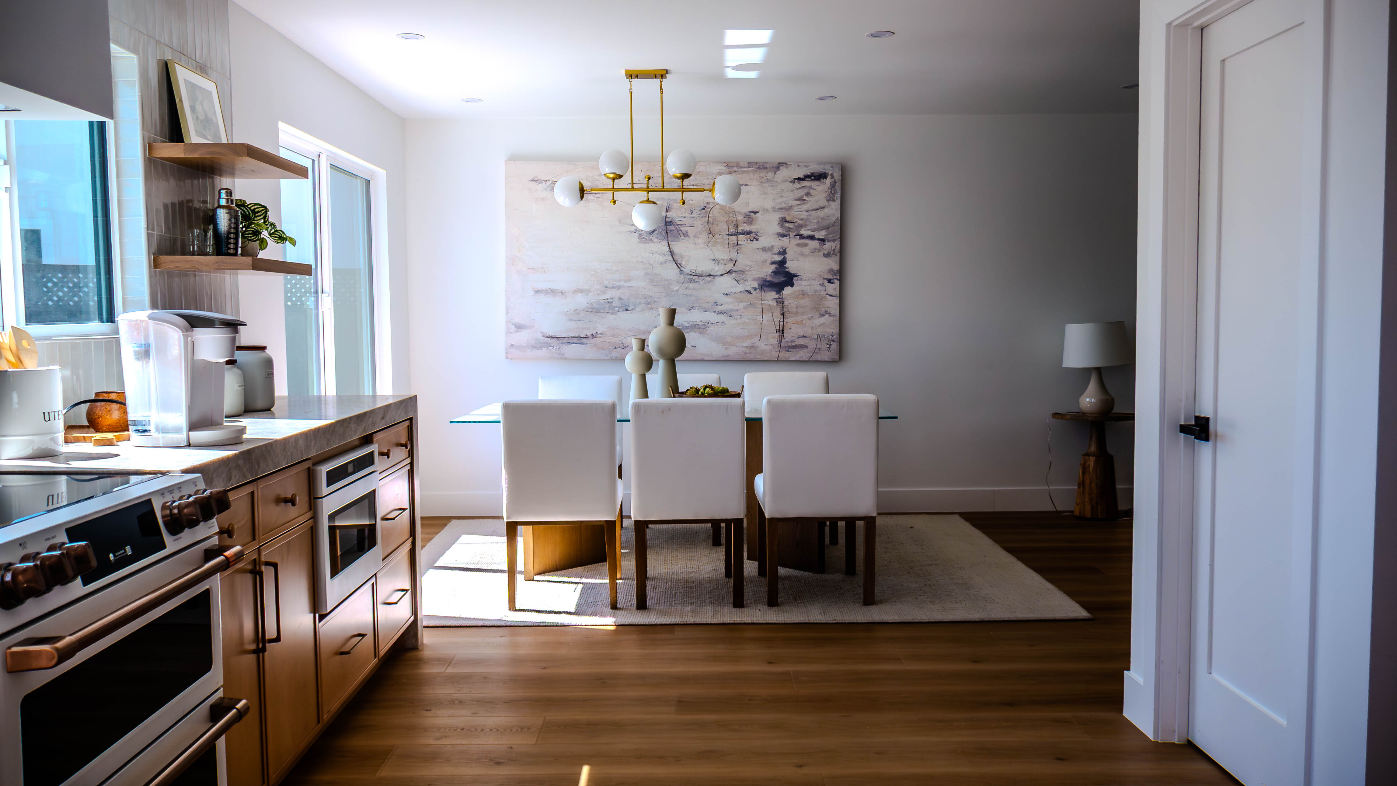 Comprehensive view of kitchen and dining spaces showing premium finishes and open concept design