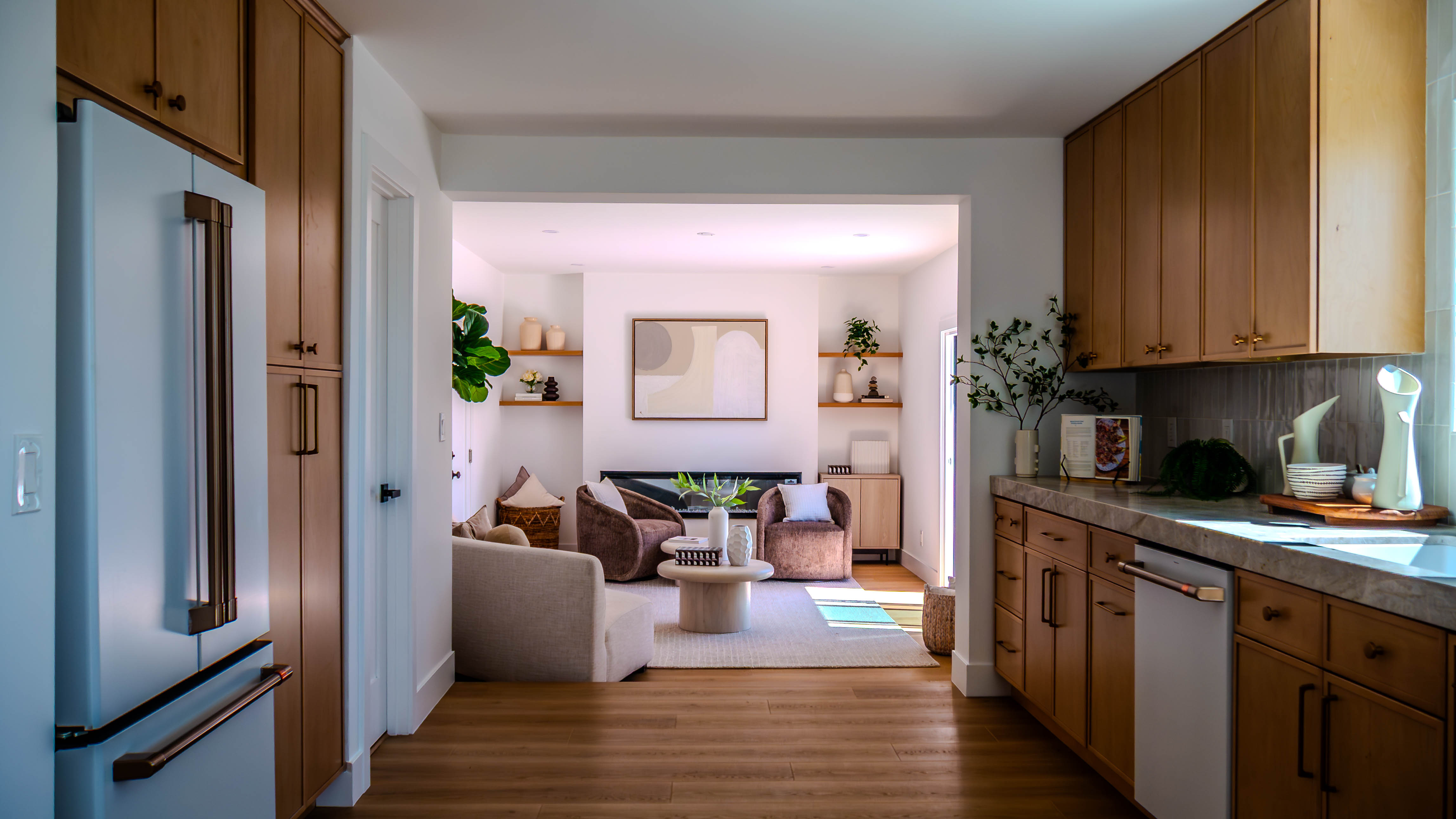 Open concept view from kitchen through to living room showing seamless flow and consistent design